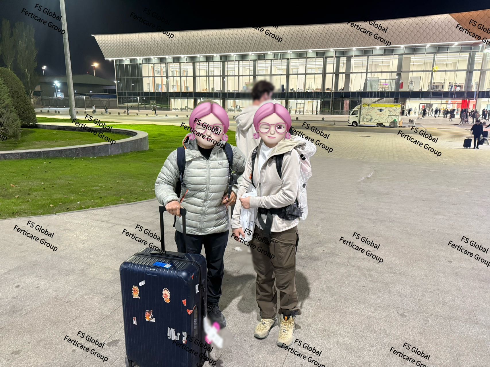 Clients with their luggage outside the airport at night.