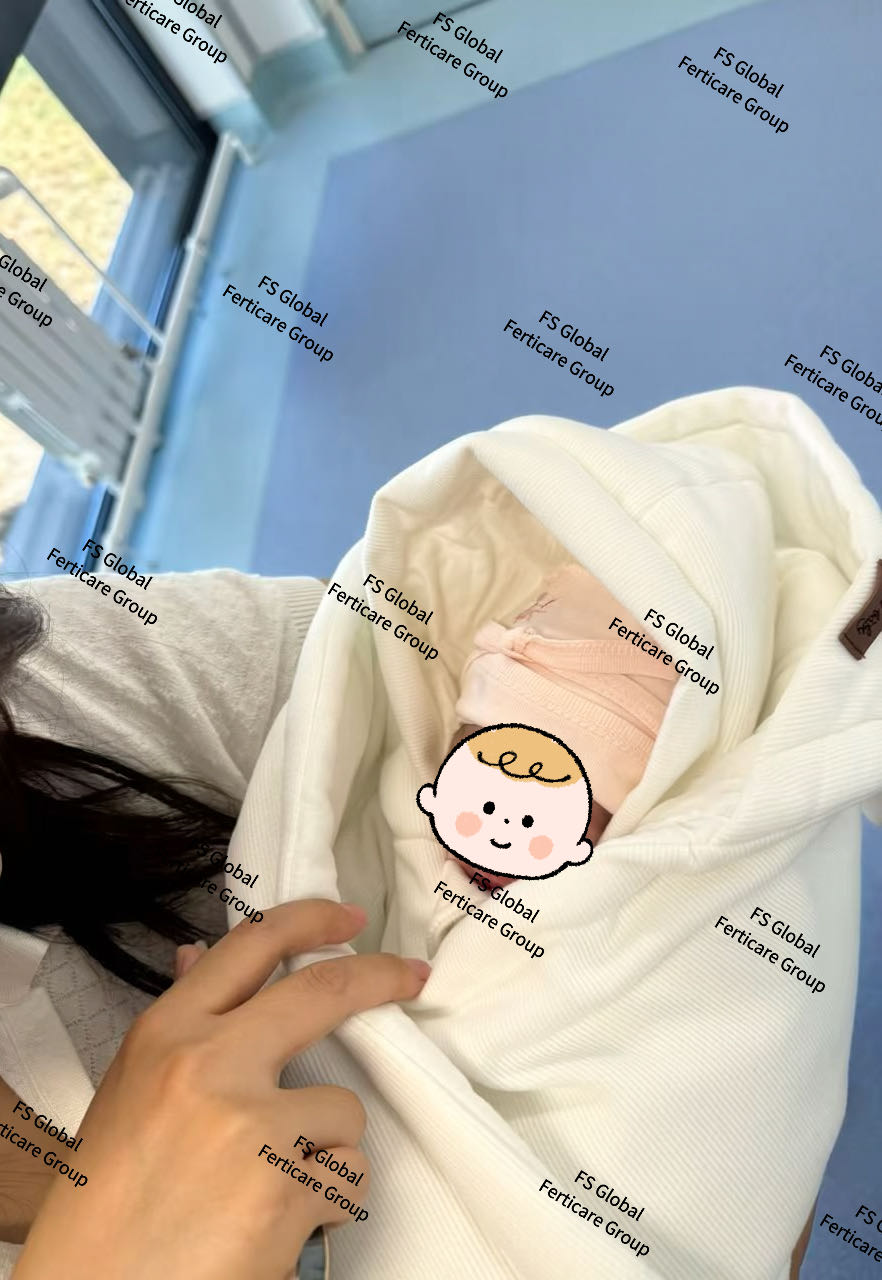 A client looks closely at the baby in her arms.